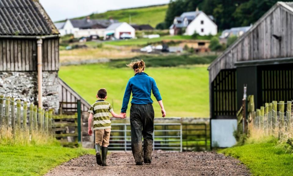 A woman and child walk on a farm near the Scottish borders, 14 August 2017.