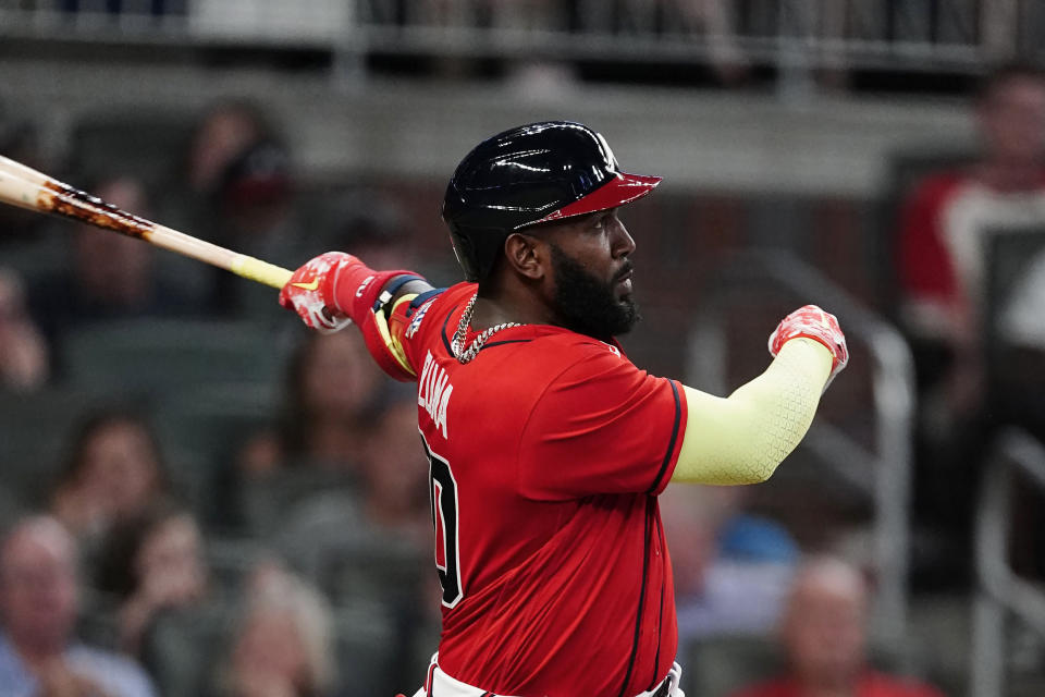 Atlanta Braves' Marcell Ozuna (20) follows through on a solo home run during the sixth inning of the team's baseball game against the Pittsburgh Pirates on Friday, May 21, 2021, in Atlanta. (AP Photo/John Bazemore)