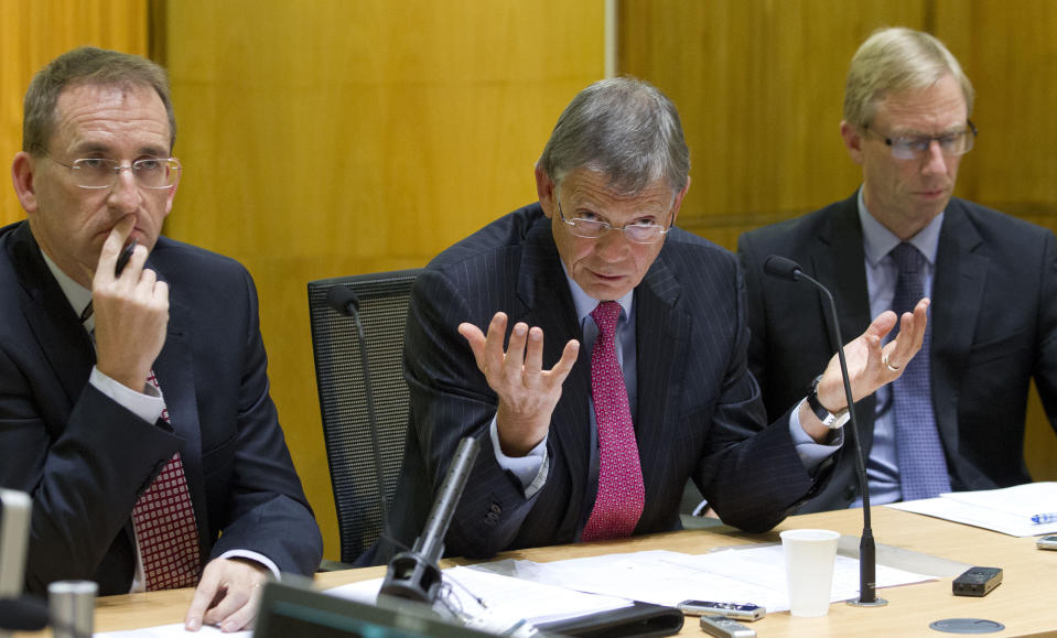 New Zealand Reserve Bank Governor Graeme Wheeler, center, comments as assistant governor John McDermott, left, and deputy governor Grant Spencer attend a press briefing after announcing its raising its benchmark interest rate by quarter of a percentage point to 2.75 percent in Wellington, New Zealand, Thursday, March 13, 2014. The South Pacific nation of 4.5 million has benefited from booming demand in China for its milk products and the gathering pace of a rebuilding effort in the city of Christchurch following an earthquake there three years ago that destroyed much of the downtown. (AP Photo/New Zealand Herald, Mark Mitchell) NEW ZEALAND OUT, AUSTRALIA OUT