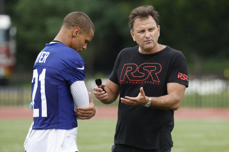 Buffalo Bills safety Jordan Poyer (21) talks with his agent Drew Rosenhaus following the NFL football team's training camp in Pittsford, N.Y., Sunday July 24, 2022. (AP Photo/ Jeffrey T. Barnes)