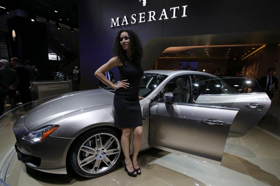 A model poses next to a Maserati quattroporte during a media preview day at the Frankfurt Motor Show (IAA) September 10, 2013. The world's biggest auto show is open to the public September 14 -22. REUTERS/Wolfgang Rattay (GERMANY - Tags: BUSINESS TRANSPORT)