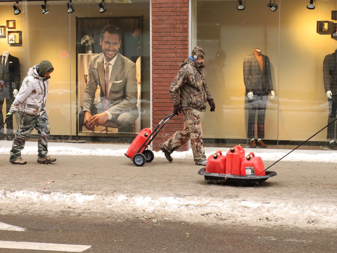 Protesters in Ottawa haul fuel to their vehicles. The Ottawa Police Service has said that anyone trying to bring 