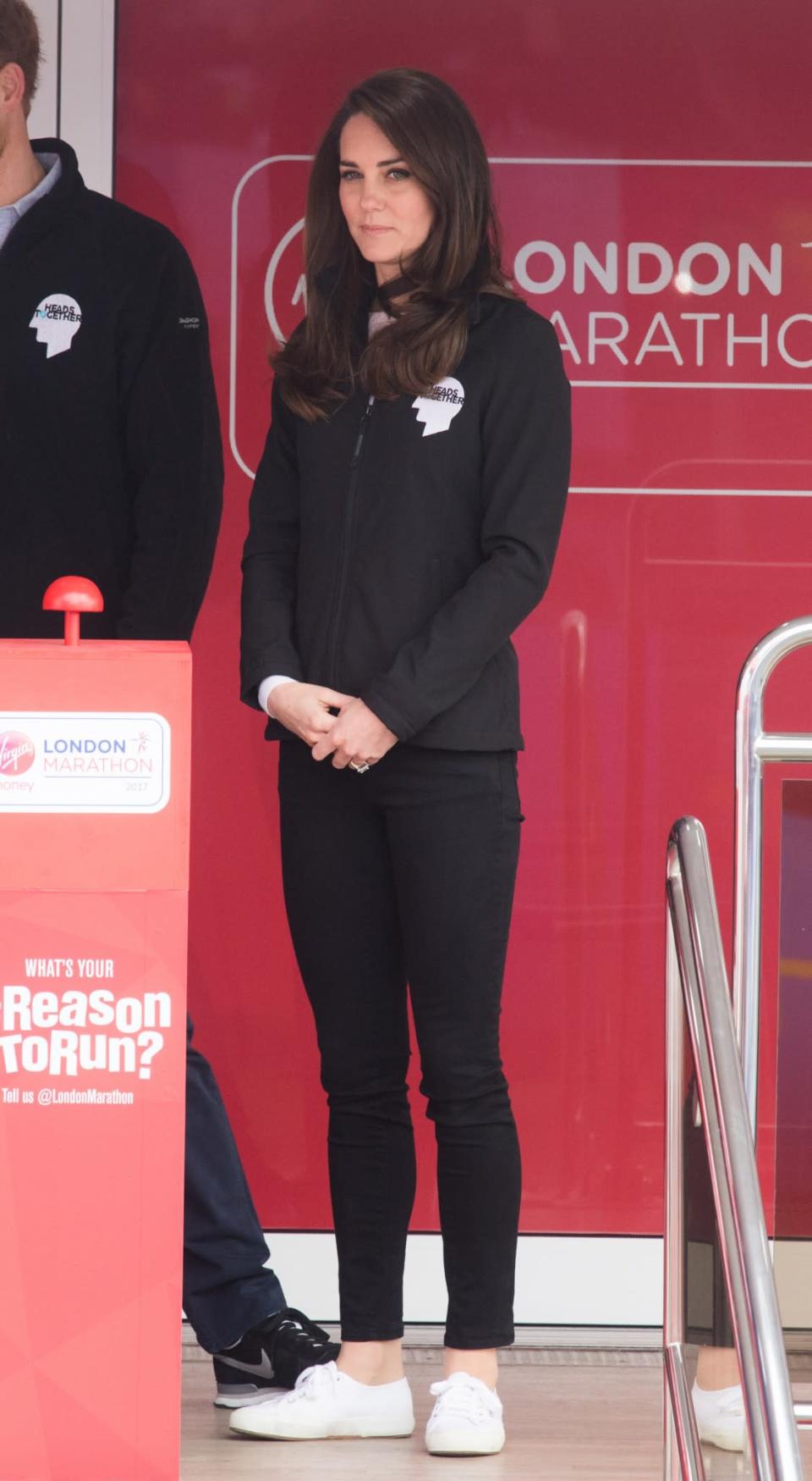 <p>Kate supported runners at the 2017 London Marathon wearing a black jacket branded with the Heads Together logo. (Heads Together is the mental health charity set up by the Duchess and Princes William and Harry.) She paired her off-duty look with skinny black jeans and a white pair of Superga trainers.<br><i>[Photo: PA]</i> </p>