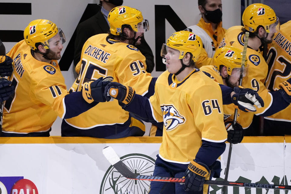 Nashville Predators center Mikael Granlund (64) is congratulated after scoring a goal against the Chicago Blackhawks in the third period of an NHL hockey game Tuesday, Jan. 26, 2021, in Nashville, Tenn. (AP Photo/Mark Humphrey)