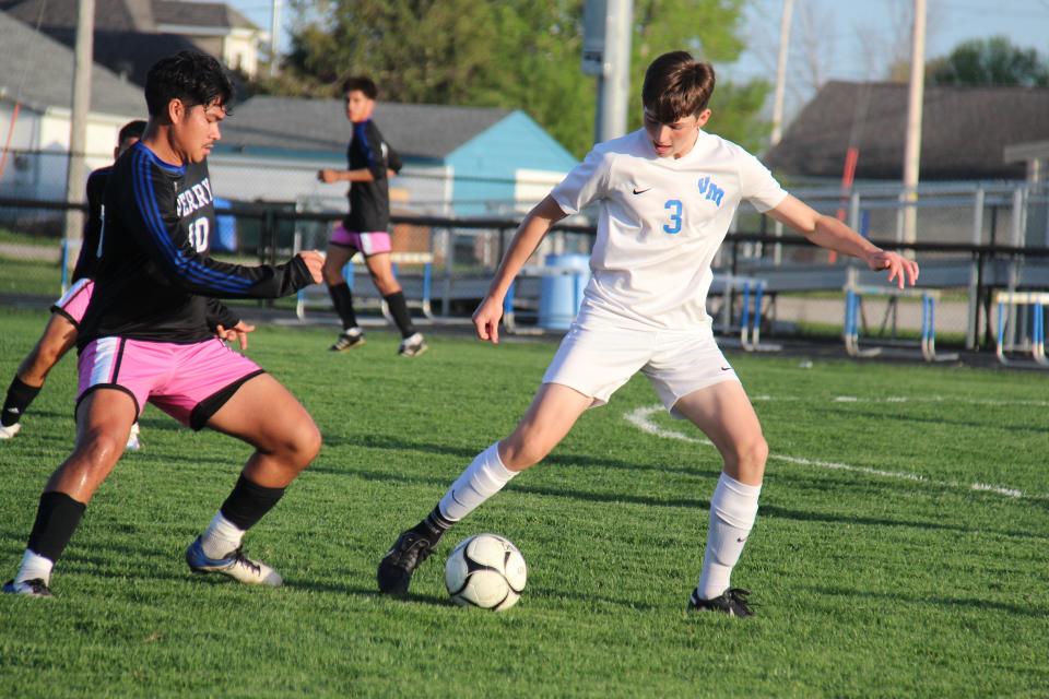 Perry's Omar Jaimes and Van Meter's Hayden Lindsey battle for the ball on Monday, May 8, 2023, at Dewey Field.