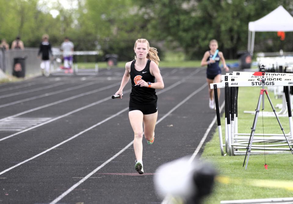 Tessa Hatt runs for Sturgis in the two-mile relay on Friday afternoon.
