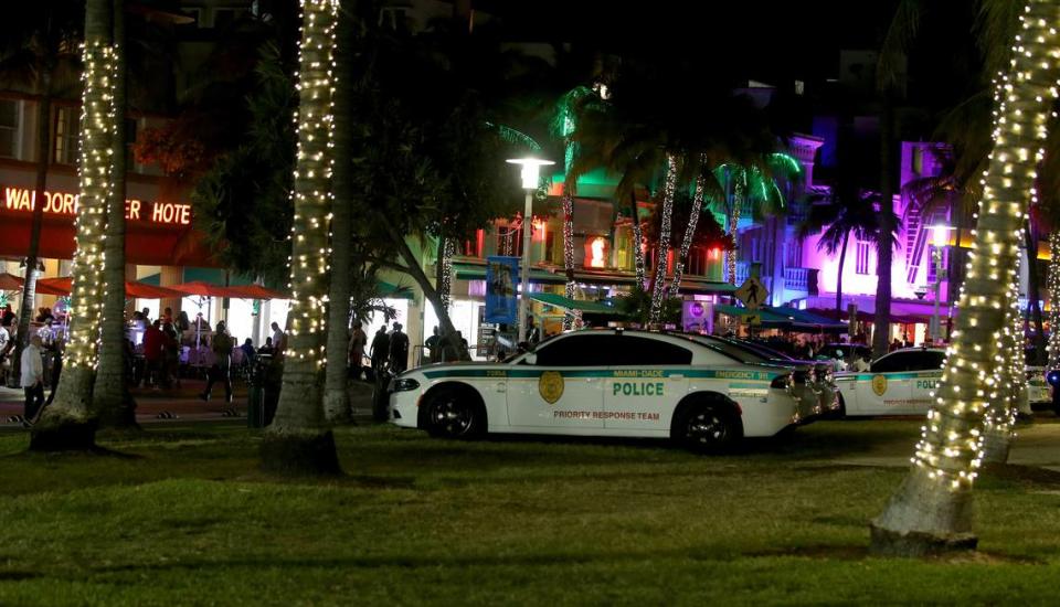 Miami-Dade Police Department is seen on Ocean Drive, on Saturday, March 26, 2022, hours before the midnight curfew imposed by the City of Miami Beach for the South Beach area, due to two shootings the weekend before that caused city officials to announce a “state of emergency”.