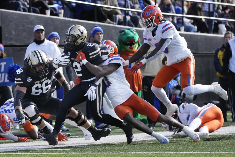 Vanderbilt running back Ray Davis (2) is driven out of bounds by Florida safety Trey Dean III (0) in the second half of an NCAA college football game Saturday, Nov. 19, 2022, in Nashville, Tenn. Vanderbilt won 31-24. (AP Photo/Mark Humphrey)