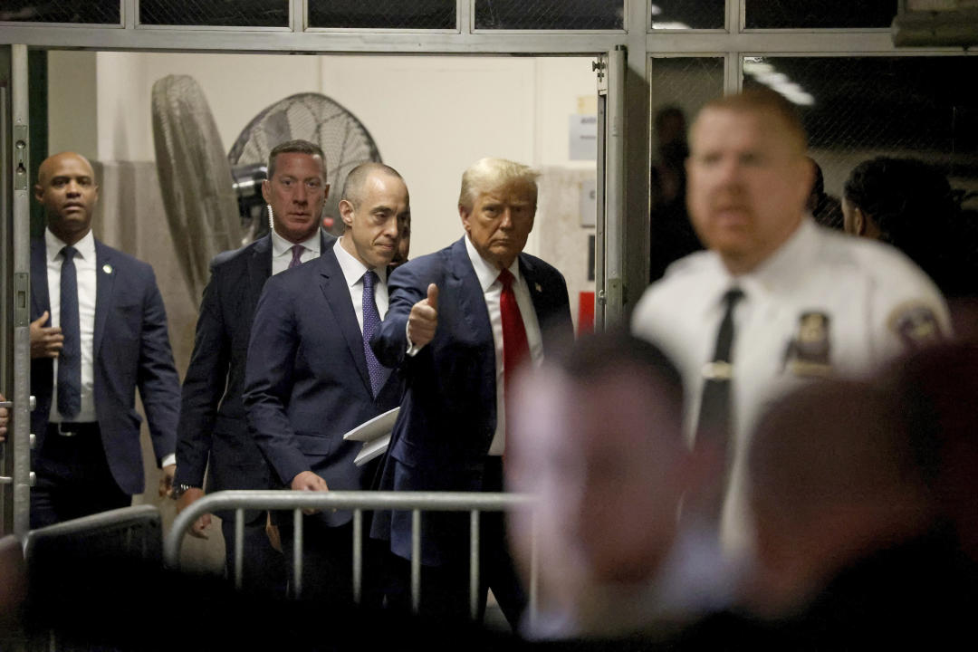 During a break, former President Donald Trump gives a thumbs-up as he appears at the Manhattan Criminal Courthouse on Thursday. 