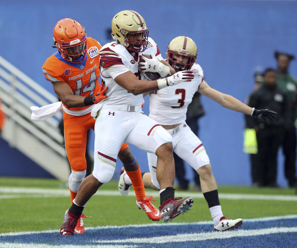 Boston College running back AJ Dillon (2) scores a touchdown ahead of Boise State cornerback Tyler Horton (14) during the first half of the First Responder Bowl NCAA football game Wednesday, Dec. 26, 2018, in Dallas. (AP Photo/Richard W. Rodriguez)