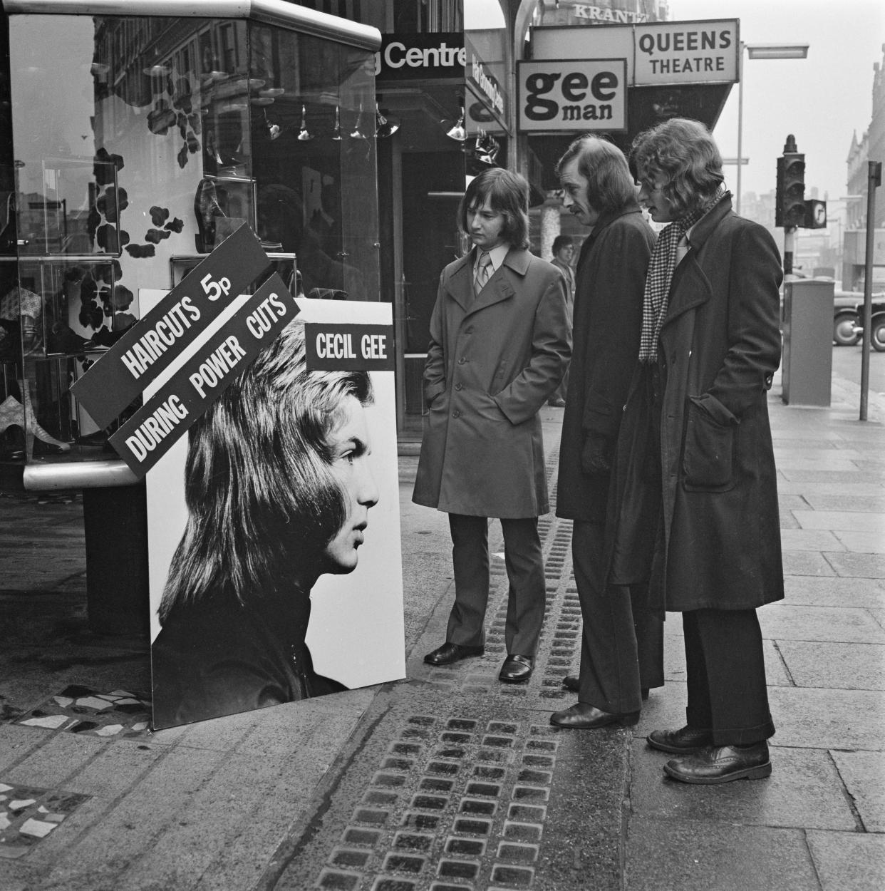 The Cecil Gee menswear store on Shaftesbury Avenue advertises haircuts for 5 pence during the power cuts in London, UK, 21st February 1972.  (Photo by Evening Standard/Hulton Archive/Getty Images)