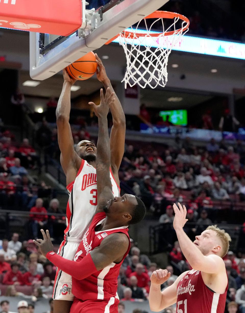 Feb. 29, 2024; Columbus, Ohio, USA; 
Ohio State Buckeyes center Felix Okpara (34) is guarded by Nebraska Cornhuskers forward Juwan Gary (4) and Nebraska Cornhuskers forward Rienk Mast (51) during the second half of an NCAA Division I men's basketball game on Thursday at Value City Arena. Ohio State won the game 78-69.