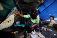 <p>A woman makes bread inside her tent at a camp for internally displaced people near Sanaa, Yemen, on May 24, 2016. (Khaled Abdullah/Reuters) </p>