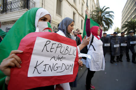 A demonstrator carries a sign as teachers and students take part in a protest demanding immediate political change in Algiers, Algeria March 13, 2019. REUTERS/Zohra Bensemra