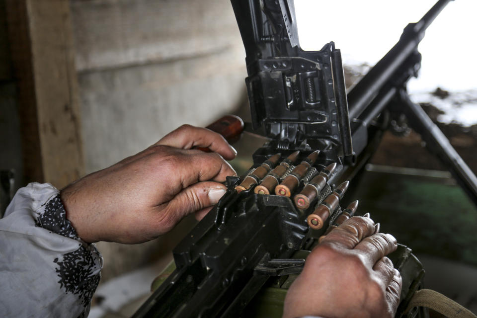 FILE - A serviceman prepares his machine-gun in a shelter on the territory controlled by pro-Russian militants at frontline with Ukrainian government forces in Slavyanoserbsk, Luhansk region, eastern Ukraine, Jan. 25, 2022. Amid fears of a Russian invasion of Ukraine, tensions have also soared in the country’s east, where Ukrainian forces are locked in a nearly eight-year conflict with Russia-backed separatists. A sharp increase in skirmishes on Thursday Feb. 17, 2022 raised fears that Moscow could use the situation as a pretext for an incursion. (AP Photo/Alexei Alexandrov, file)