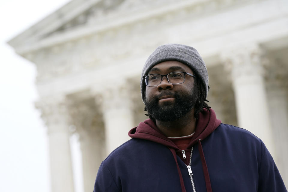 FILE - Evan Milligan, plaintiff in Merrill v. Milligan, an Alabama redistricting case, listens to a reporter's question following oral arguments outside the Supreme Court on Capitol Hill in Washington, Oct. 4, 2022. The Supreme Court on Thursday, June 8, 2023, issued a surprising ruling in favor of Black voters in a congressional redistricting case, ordering the creation of a second district with a large Black population. (AP Photo/Patrick Semansky, File)