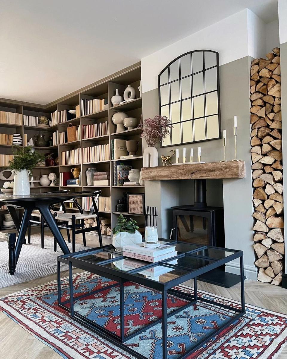 a room with a table and bookshelves