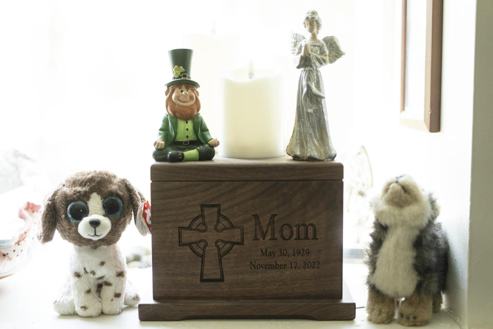 A wooden urn with the remains of Georgene White's mother, Teri Sheridan, sits near a window in Belvidere, N.J., Thursday, April 20, 2023. At age 93, struggling with the effects of a stroke, heart failure and recurrent cancer, Sheridan was ready to end her life using New Jersey's law that allows medically assisted suicide - but she was bedbound, too sick to travel. So on Nov. 17, 2022, surrounded by three of her children, Sheridan drank a lethal dose of drugs prescribed by a doctor she had never met in person, only online. She died within minutes. (AP Photo/Matt Rourke)