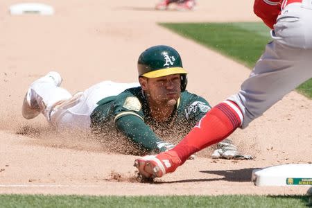 Jun 16, 2018; Oakland, CA, USA; Oakland Athletics shortstop Chad Pinder (18) slides into third base against the Los Angeles Angels during the seventh inning at the Oakland Coliseum. Mandatory Credit: Stan Szeto-USA TODAY Sports