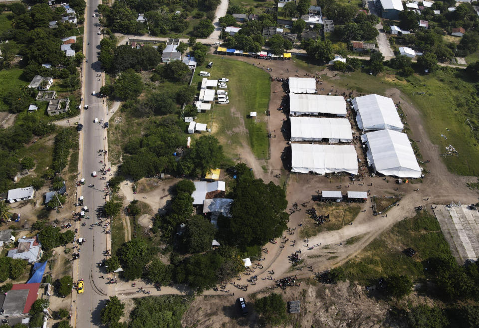 Tents are set up by Mexican migration authorities in San Pedro Tapanatepec, Oaxaca, Mexico Wednesday, Oct. 5, 2022. Officials here issued transit permits until the camp was closed in mid December. Before getting here, some migrants said they spent several days in detention in Tapachula; others said they were released immediately. Some were let go for free and others after paying up to $500 to a lawyer. (AP Photo/Marco Ugarte)