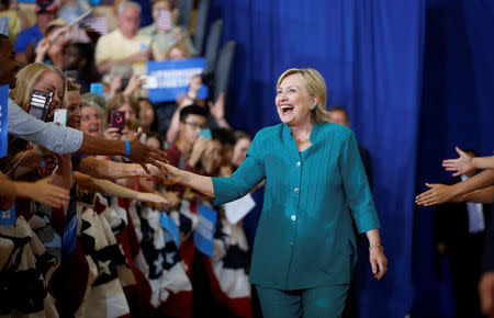Democratic presidential nominee Hillary Clinton smiles as she greets supporters while arriving for a rally at Lincoln High School in Des Moines, Iowa August 10, 2016. REUTERS/Chris Keane
