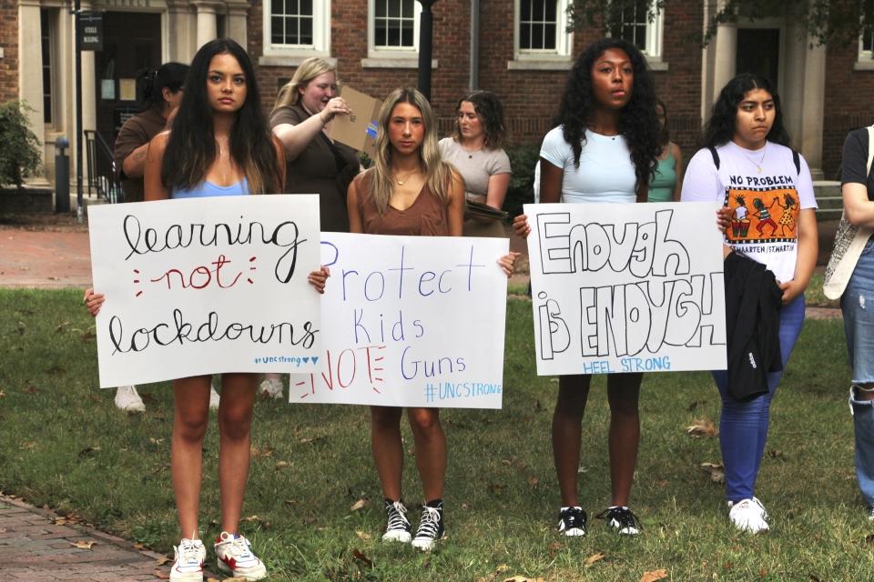 Students hold protest signs during a gun safety rally following a fatal shooting earlier in the week on the University of North Carolina at Chapel Hill campus, Wednesday, Aug. 30, 2023, in Chapel Hill, N.C. (AP Photo/Hannah Schoenbaum)