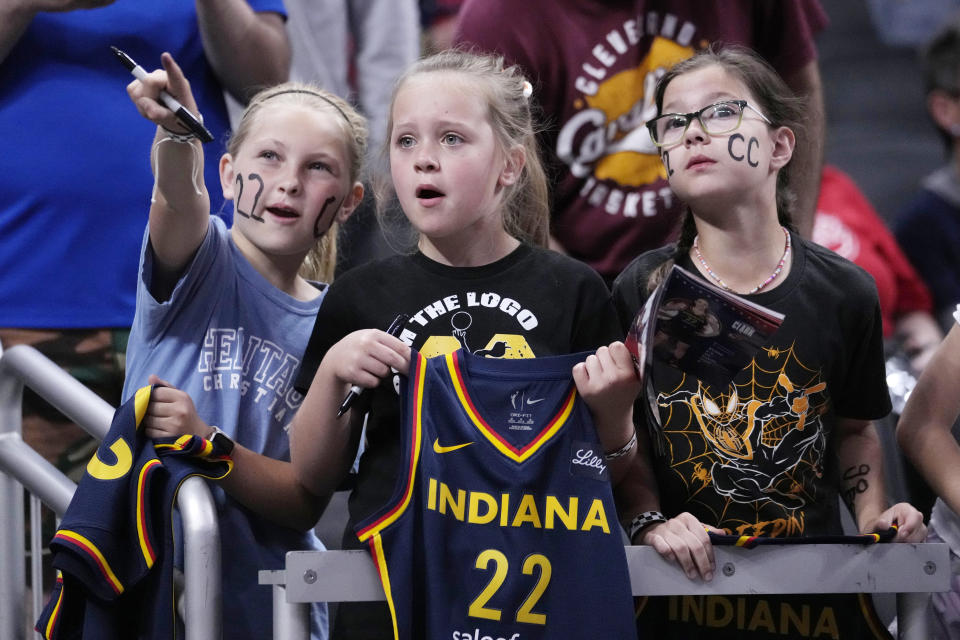 FILE - Fans watch Indiana Fever guard Caitlin Clark warm up for the team's WNBA basketball game against the New York Liberty, Thursday, May 16, 2024, in Indianapolis. (AP Photo/Michael Conroy, File)