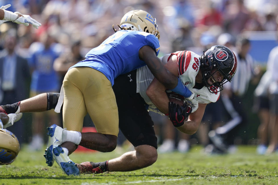 Utah tight end Dalton Kincaid (86) is tackled by UCLA defensive back Mo Osling III (7) during the first half of an NCAA college football game in Pasadena, Calif., Saturday, Oct. 8, 2022. (AP Photo/Ashley Landis)