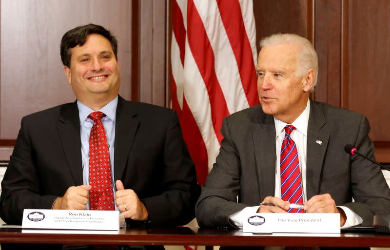FILE PHOTO: U.S. Vice President Joe Biden is joined by Ebola Response Coordinator Ron Klain (L) in the Eisenhower Executive Office Building on the White House complex in Washington