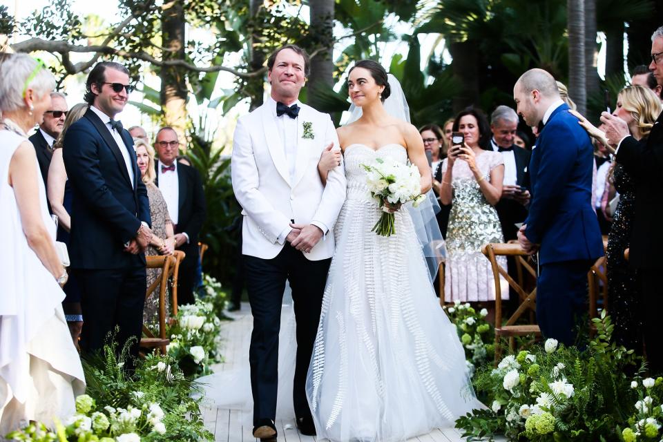 The bride wore Oscar de la Renta, inspired by her grandmother, for her greenery-filled ceremony at the Beverly Hills Hotel.