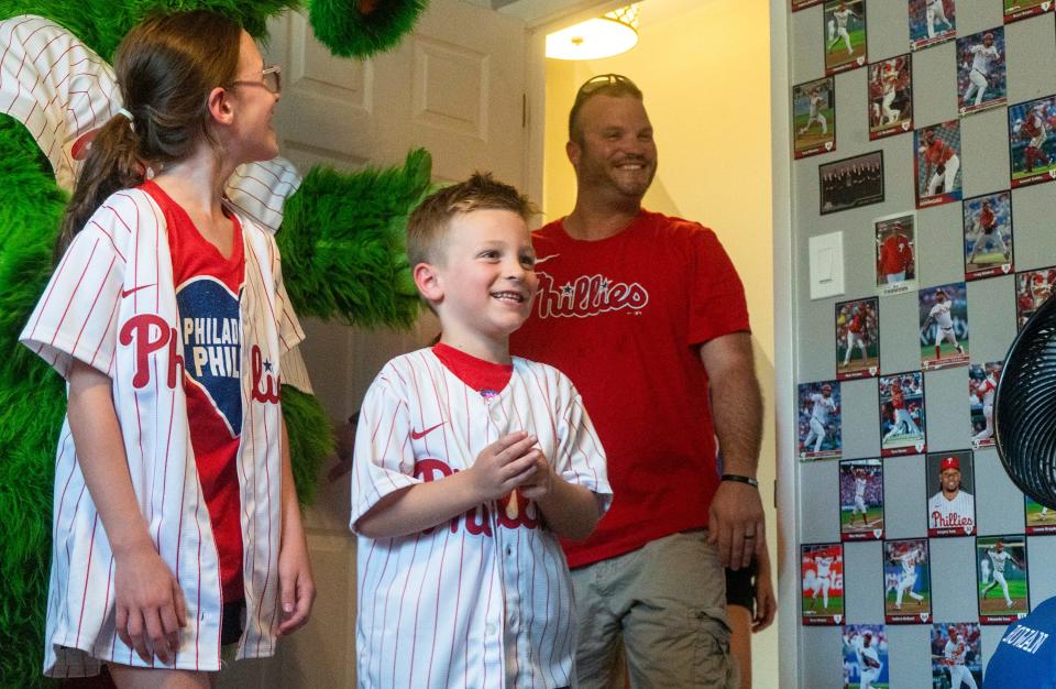 Aubrey (9), left, with Rowan Linder, center, a 5 year-old big-time baseball fan who is battling cancer, and their dad Gary Linder, right, take the first look at Rowan's new Phillies-themed bedroom decorated by members of the Phillies Front Office in Middletown on Thursday, Sept. 7, 2023.

[Daniella Heminghaus | Bucks County Courier Times]