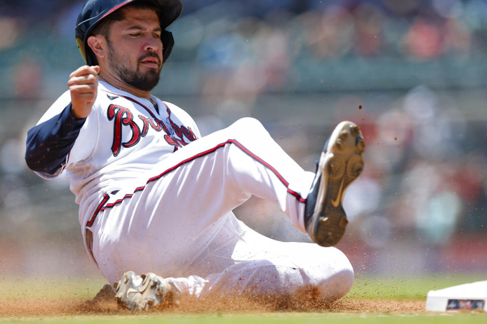 Atlanta Braves' Travis d'Arnaud slides into third in the fourth inning of a baseball game against the San Francisco Giants, Thursday, June 23, 2022, in Atlanta. (AP Photo/Todd Kirkland)