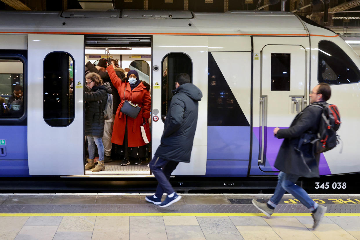 Passengers run to catch one of the final westbound Elizabeth Line trains at Paddington Station, as British rail workers kicked off the new year with a week-long strike, in London, Britain, January 3, 2023.    REUTERS/Kevin Coombs