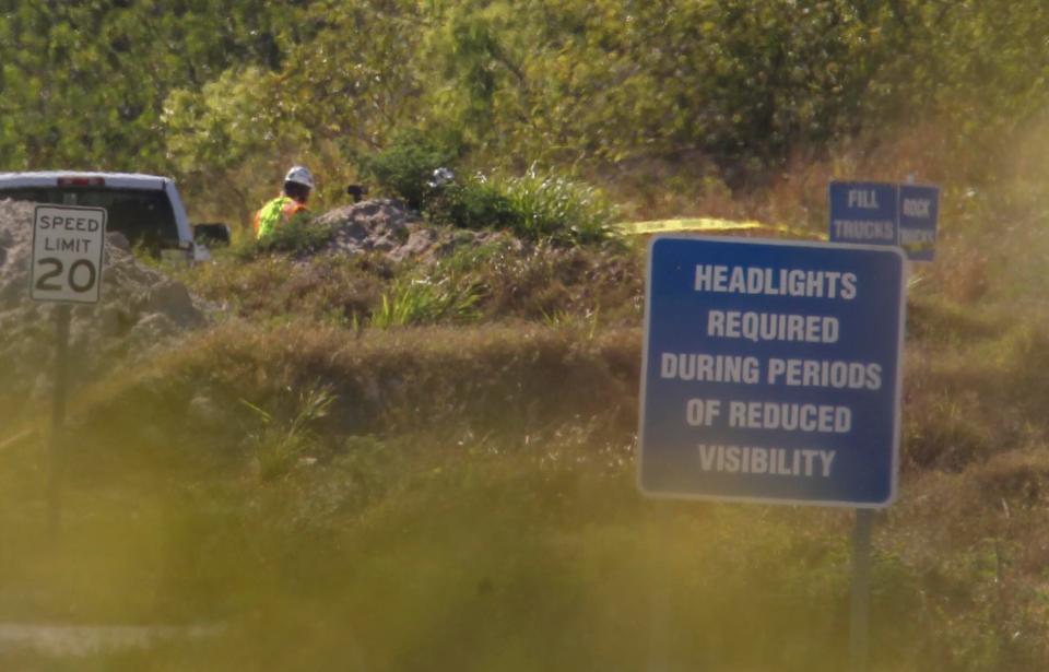 Workers are seen in an area marked off with tape as investigators with the  U.S. Department of Labor’s Mine Safety and Health Administration investigate the accident involving a mine crew member at the Vulcan Materials quarry along Range Line Road on Thursday, March 16, 2023, in western St. Lucie County.