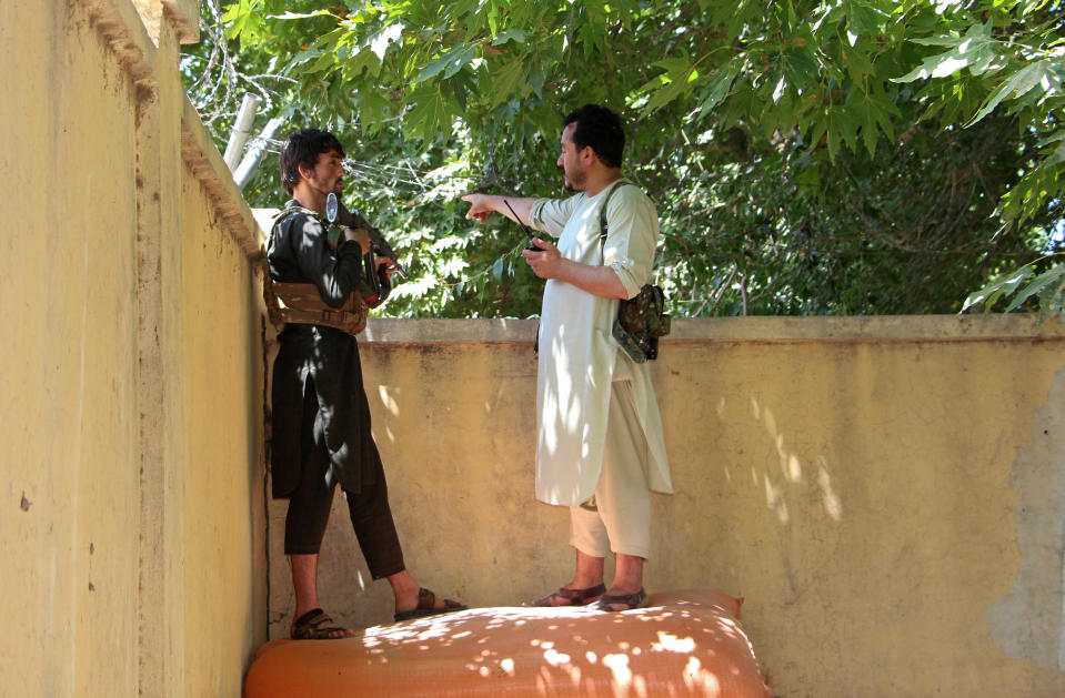 Afghan security personnel stand behind a wall during fighting between Taliban and Afghan security forces in Kunduz city, north of Kabul, Afghanistan, Thursday, June 24, 2021. Taliban gains in north Afghanistan, the traditional stronghold of the country's minority ethnic groups who drove the insurgent force from power nearly 20 years ago, has driven a worried government to resurrect militias whose histories have been characterized by chaos and widespread killing. (AP Photo/Samiullah Quraishi)