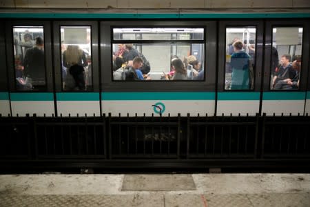 Commuters are seen in a metro at the Gare du Nord subway station during a strike by all unions of the Paris transport network (RATP) against pension reform plans in Paris