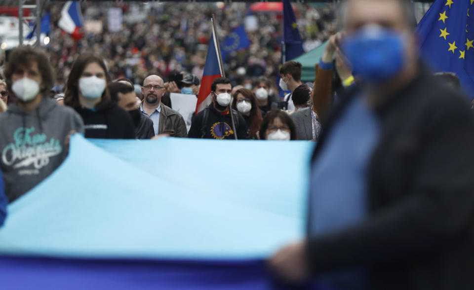 People attend a demonstration in Prague, Czech Republic, Thursday, April 29, 2021. Thousands of Czechs have rallied in the capital against President Milos Zeman, accusing him of treason for his pro-Russian stance over the alleged participance of Russian spies in a Czech huge ammunition explosion. (AP Photo/Petr David Josek)