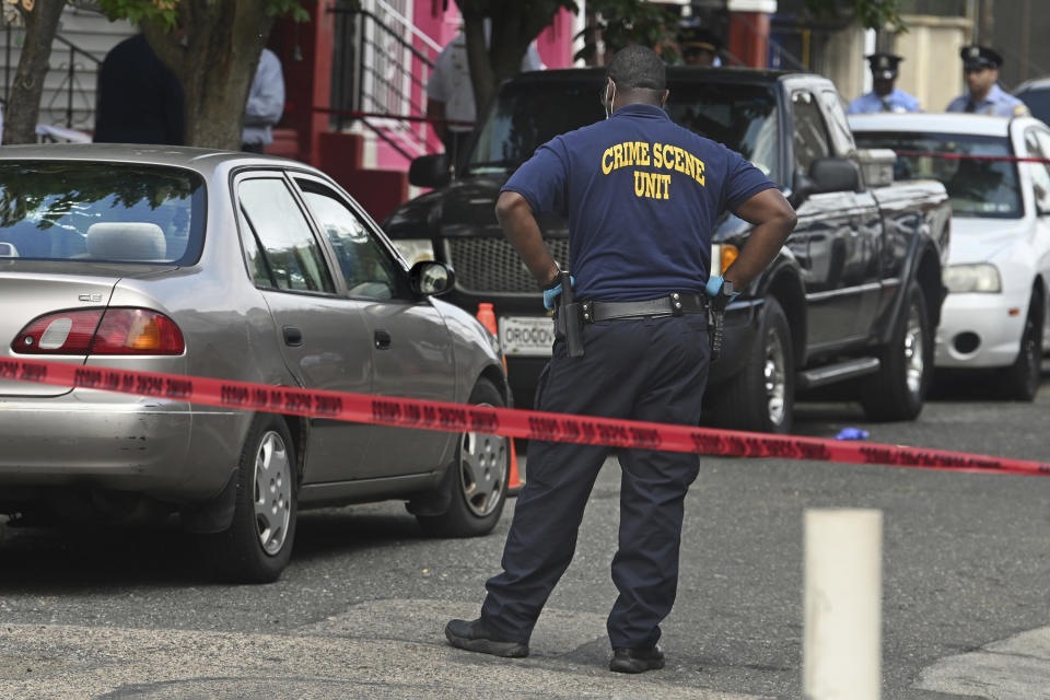 FILE - Police investigators are on the scene of a shooting Monday, Aug. 14, 2023 in Philadelphia. Officer Mark Dial who shot and killed a driver who was sitting in his car turned himself in Friday, Sept. 8 to face criminal charges. (Tom Gralish/The Philadelphia Inquirer via AP)