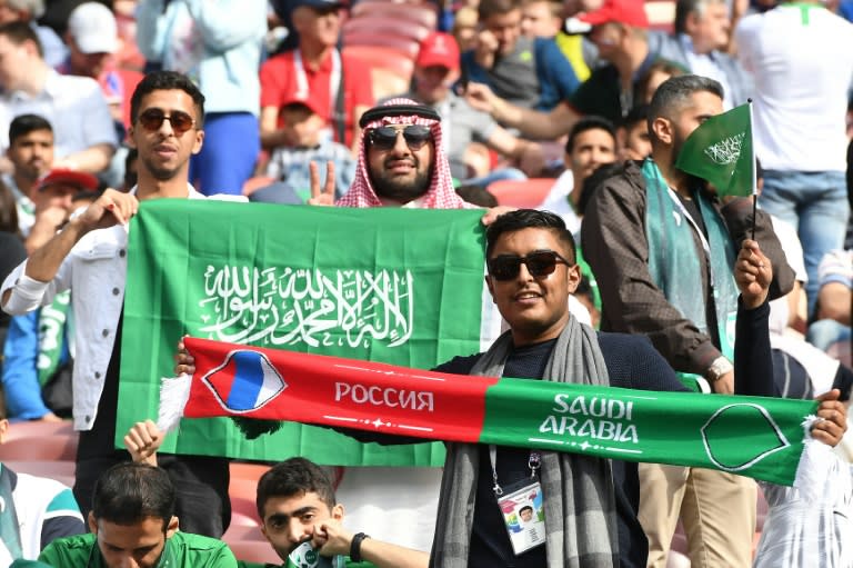 Saudi Arabia fans hold scarves and flags before the start of the Russia 2018 World Cup Group A football match between Russia and Saudi Arabia at the Luzhniki Stadium in Moscow on June 14, 2018