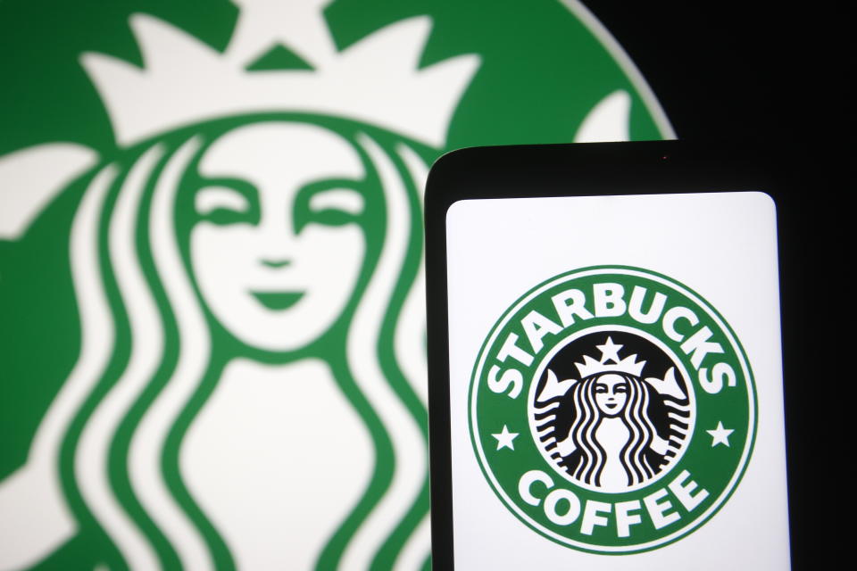 UKRAINE - 2021/02/21: In this photo illustration, Starbucks logo is seen displayed on a smartphone and pc screen. (Photo Illustration by Pavlo Gonchar/SOPA Images/LightRocket via Getty Images)