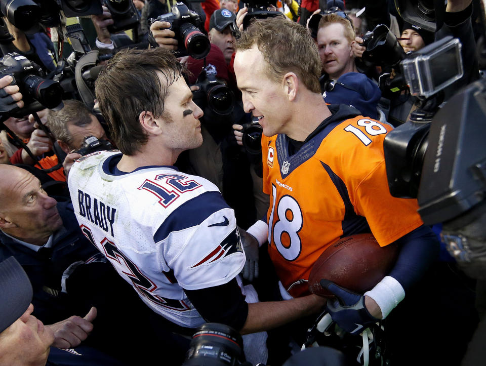 FILE - In this Jan. 24, 2016, file photo, New England Patriots quarterback Tom Brady, left, and Denver Broncos quarterback Peyton Manning speak to one another following the NFL football AFC championship game in Denver. The next match involving Tiger Woods and Phil Mickelson involves a $10 million donation for COVID-19 relief efforts, along with plenty of bragging rights in a star-powered foursome May 24 at Medalist Golf Club. Turner Sports announced more details Thursday, May 7, 2020, for “The Match: Champions for Charity,” a televised match between Woods and Peyton Manning against Mickelson and Tom Brady. (AP Photo/David Zalubowski, File)