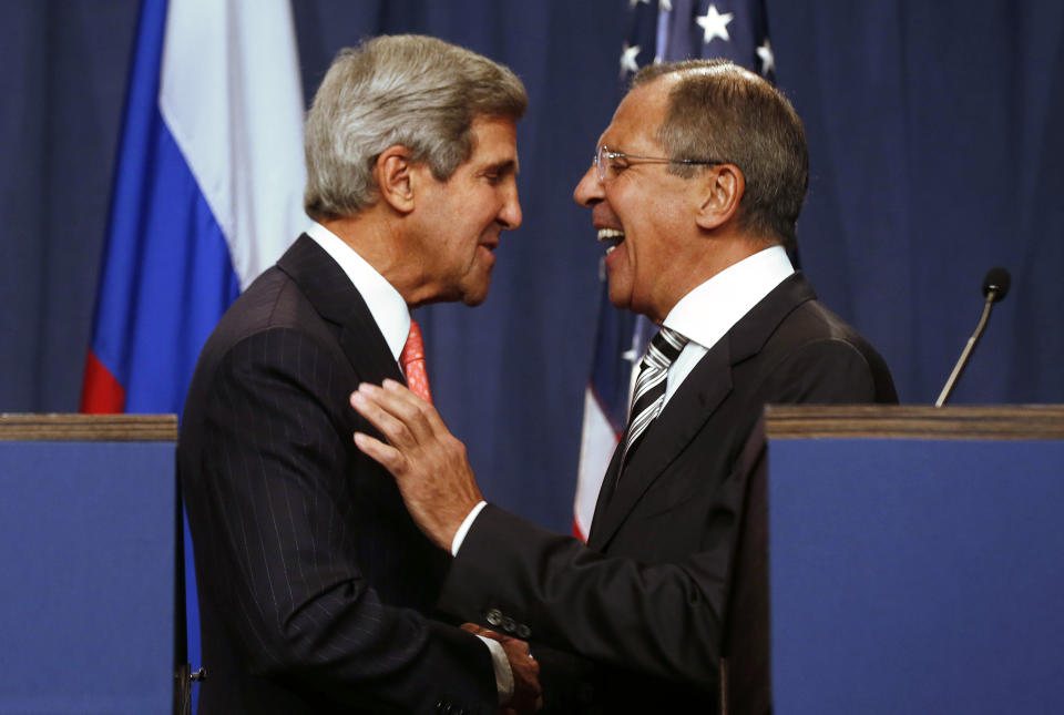 U.S. Secretary of State John Kerry (L) and Russian Foreign Minister Sergei Lavrov (R) shake hands after making statements following meetings regarding Syria, at a news conference in Geneva September 14, 2013. The United States and Russia have agreed on a proposal to eliminate Syria's chemical weapons arsenal, Kerry said on Saturday after nearly three days of talks with Lavrov. (REUTERS/Larry Downing)