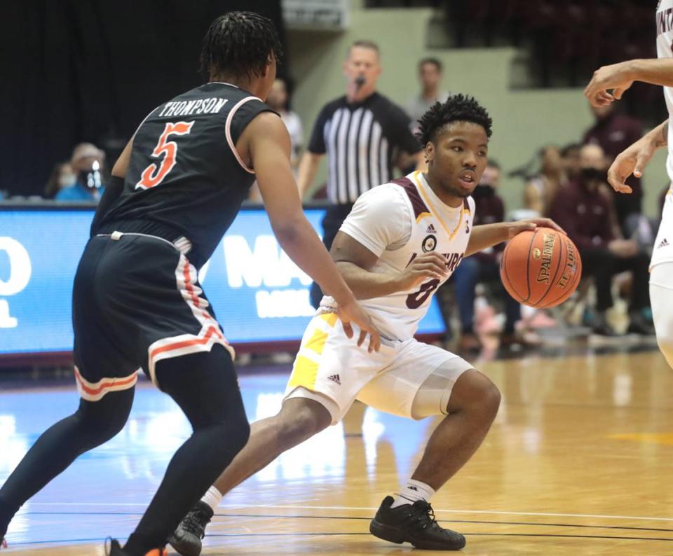 Winthrop’s Russell Jones Jr. looks for an opening around Campbell’s Messiah Thompson