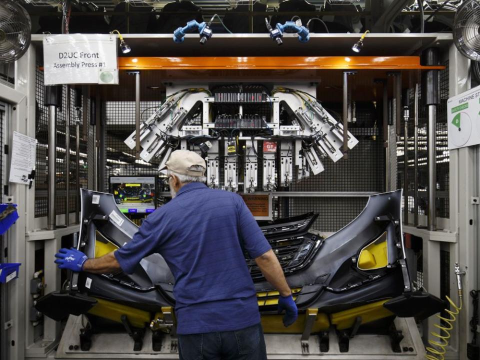  An employee assembles a bumper at the Magna International Inc. Polycon Industries auto parts manufacturing facility in Guelph, Ont.