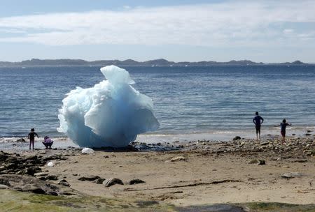 Children play amid icebergs on the beach in Nuuk, Greenland, June 5, 2016. REUTERS/Alister Doyle