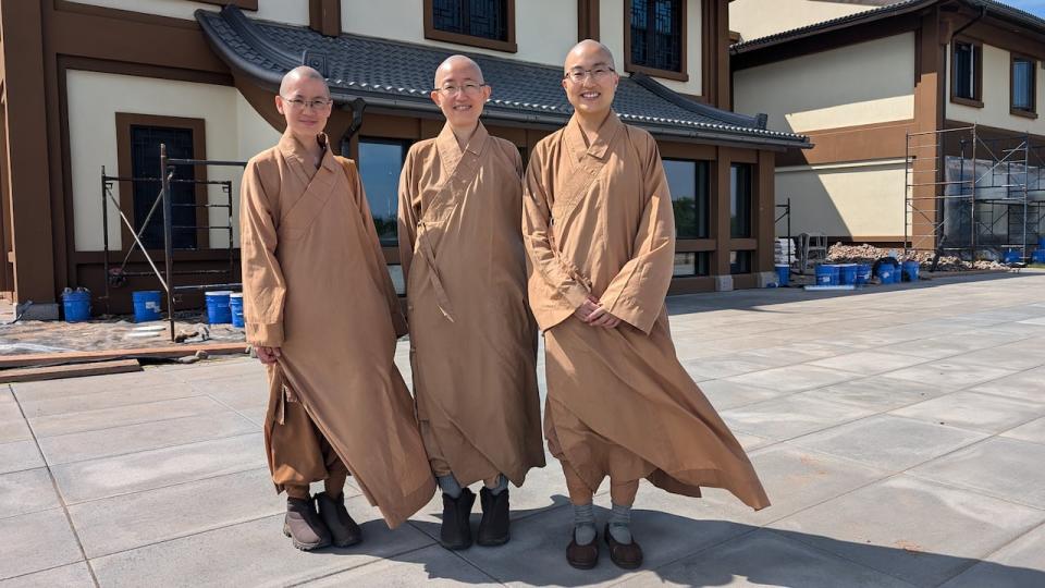 Buddhist nuns, from left, Joanna Ho, Heather Chang and Sabrina Chiang will be welcoming the public inside the Great Wisdom Buddhist Institute's new monastery in Brudenell this weekend.