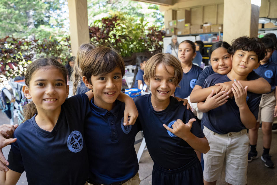Sacred Hearts third grade students line up before recess at Sacred Hearts Mission Church on Tuesday, Oct. 3, 2023, in Lahaina, Hawaii. Sacred Hearts School, a Catholic school, was founded in 1862. Most of the school burned down, but its leaders quickly got classes up and running at Sacred Hearts Mission Church 10 miles (16 kilometers) away. (AP Photo/Mengshin Lin)