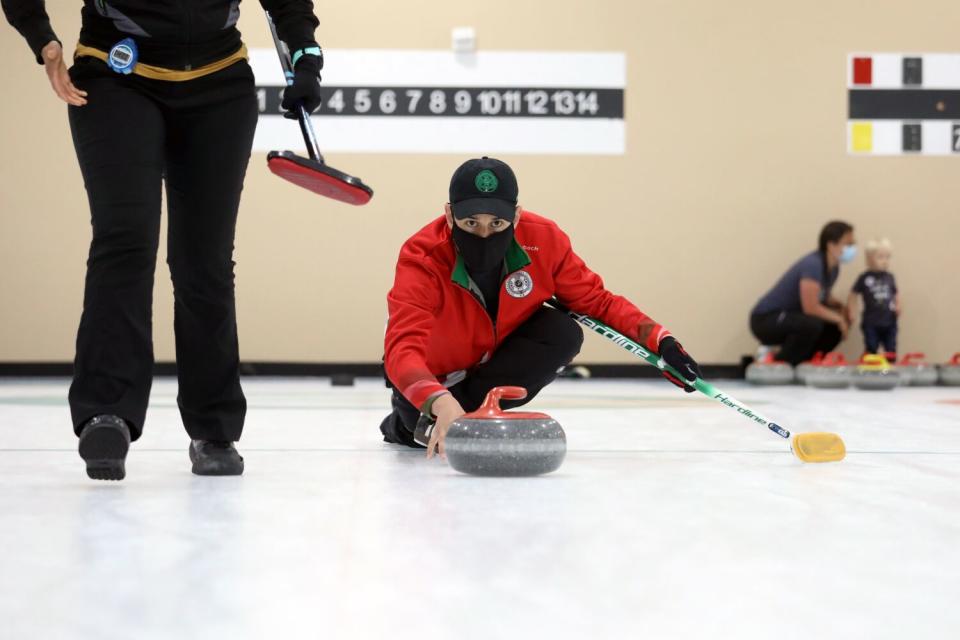 Former Mexican national curling team member Jesus Barajas, 46, of Oakland, delivers at San Francisco Bay Area Curling Club.