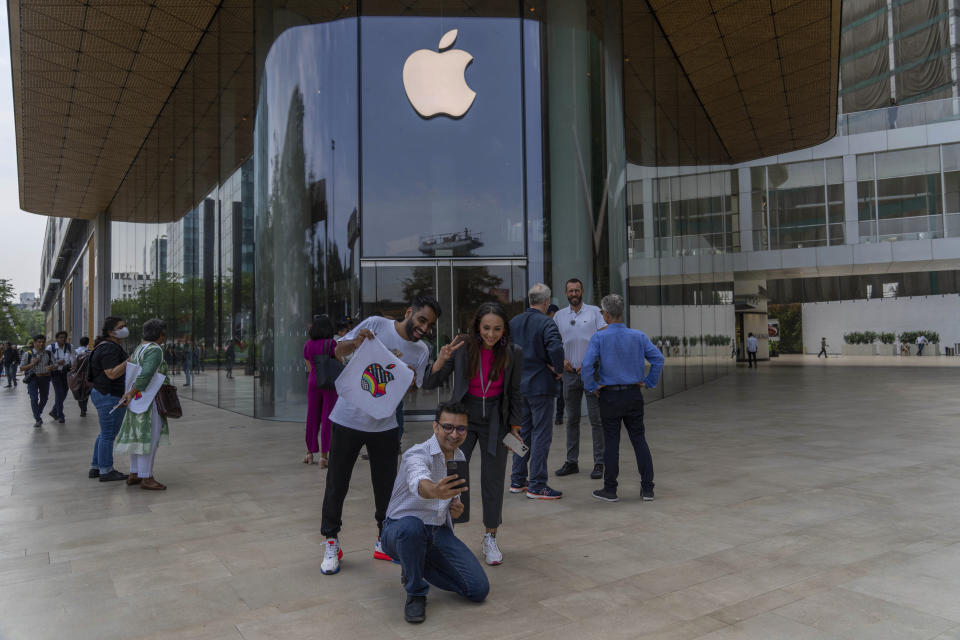 Invitees takes pictures during a press preview of India's first Apple Store in Mumbai, India, Monday, April 17, 2023. Apple will open its first retail store in India in Mumbai on Tuesday. (AP Photo/Rafiq Maqbool)