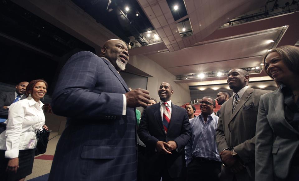 This Aug. 13, 2012 photo shows Bishop T.D. Jakes, foreground, chatting with a group of young adults he mentors at the Potters House in Dallas. Bishop Jakes work as a film producer has motivated him to mentor more young people. As producer for the remake of Sparkle staring Whitney Houston, Jakes and others see Houston's spirit of mentoring and true-to-life role in the film, in which she plays a singer trying to raise her children in the church so they avoid some of the mistakes she made during her career. (AP Photo/LM Otero)